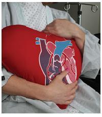 photo of patient hugging a heart pillow